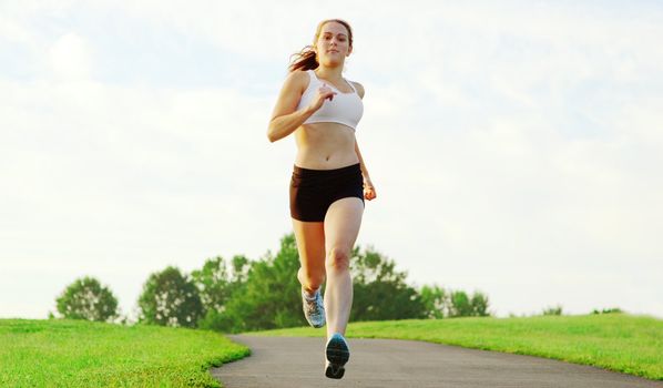 Beautiful young woman runner having a workout session.