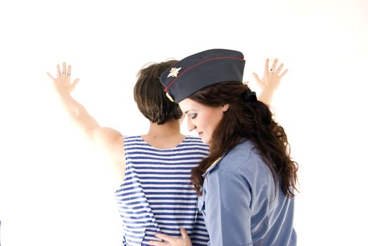 Young woman in police uniform arresting a criminal