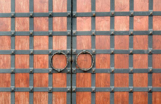 Old wooden closed textured door.metal handle on old wood door