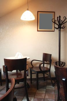 Table and chairs under a lamp in cafe