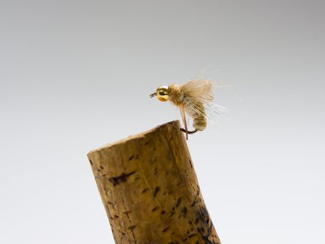 an imitation of a fly to use it for trout fishing