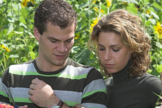 Young couple working together in the garden