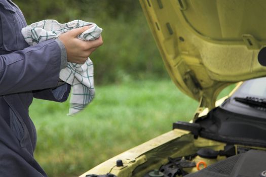 Female hands cleaning after having worked on the interior of the car