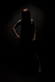 Portrait of a young  brunette in darkness