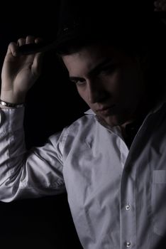 Portrait of a young dark-haired man-cowboy style