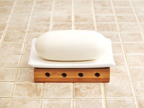 Bathroom object photographed against a stone tile backdrop.