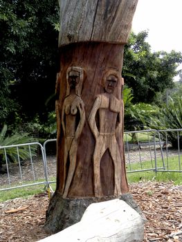 Photo presents sculpture of a woman and a man in a tree.