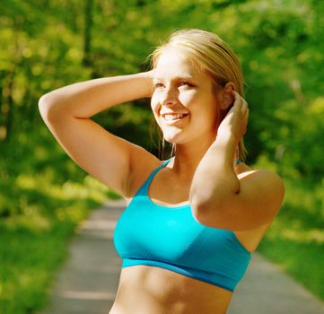 Young woman working out on a forest path.