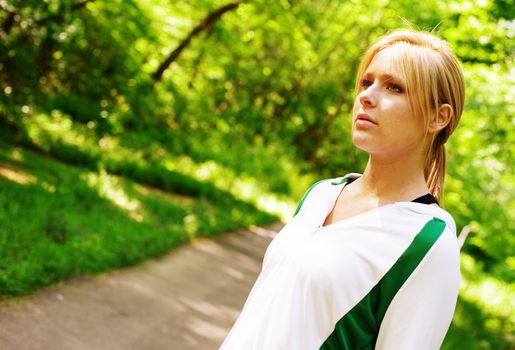 Young woman working out on a forest path.