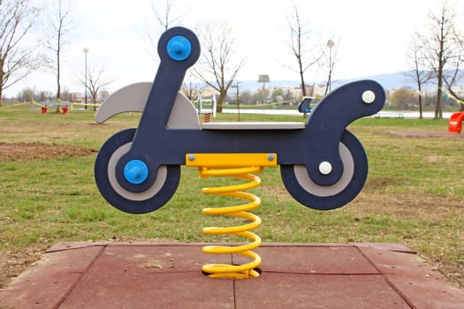 Motorbike spring swing toy in a playground