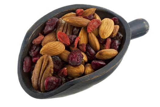 almonds, pecans, dried cranberries, cherries and goji (Tibetan wolfberry) on a rustic wooden scoop, isolated on white