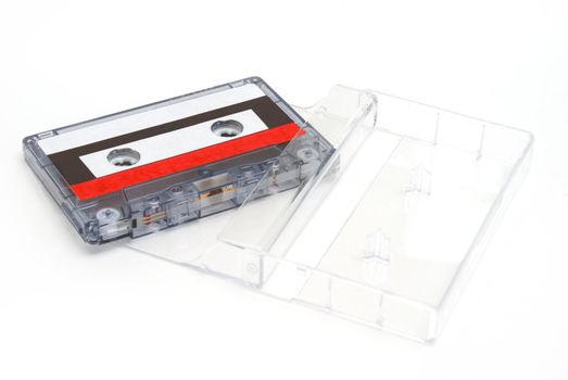 A cassette tape with its case on white background.