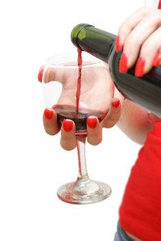A woman is pouring a glass of red wine.