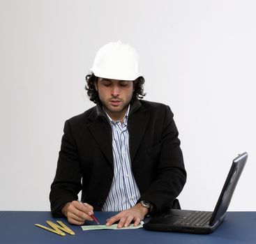 Young architect at work Writing a check