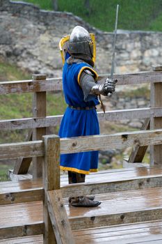 CESIS, LATVIA, June 7, 2009: Knight before swordfight on wooden bridge during the medieval festival "Livonia. 1378. Wenden". Rainy day.