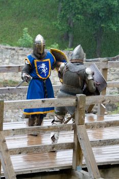 CESIS, LATVIA, June 7, 2009: Knight before swordfight on wooden bridge during the medieval festival "Livonia. 1378. Wenden". Rainy day.