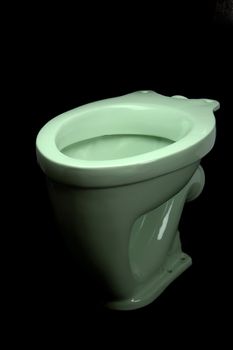 The light green toilet bowl, isolated on black background