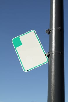 Blank parking sign on the pole on sunny day