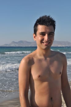 smiling young man at Kos beach in Greece (blue sky)