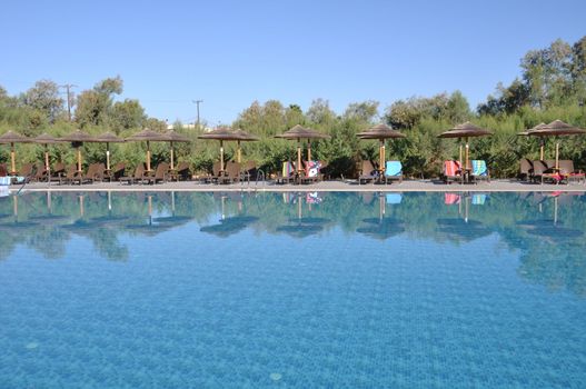 gorgeous resort swimming pool with umbrellas during daytime