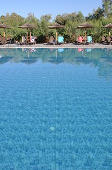 gorgeous resort swimming pool with umbrellas during daytime