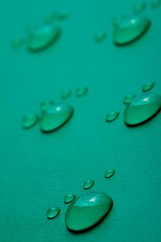 Footprints accomplished on the basis of drops of water on a green background