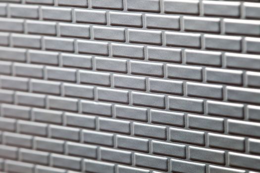 A wall formed by metal bricks
