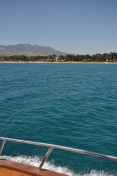 ancient windmill at Kos coastline, Greece (boat view)