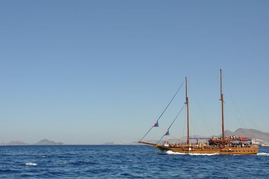 KOS - AUGUST 26 2010: passengers on board, antique ship is cruising the blue sea on August 26, 2010 in Kos, GREECE