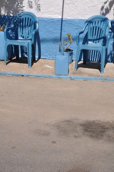 gorgeous greek scene with blue chairs