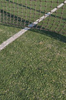 white lines on an outdoor tennis court (artificial grass)