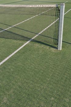 white lines on an outdoor tennis court (artificial grass)