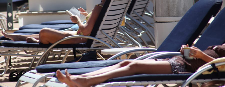 Women relaxing on the deck of a cruise ship.