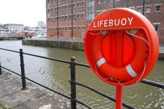orange buoy foam lifesaving ring at Gloucester docks in England, UK