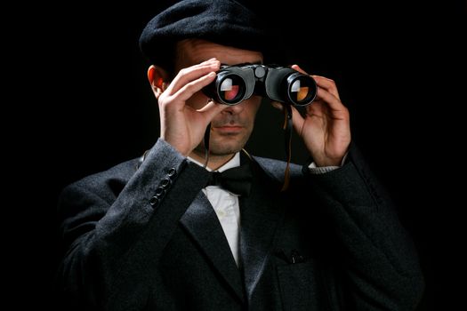 Old fashioned man look through the binoculars 