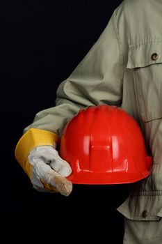 man holding red helmet over black background 