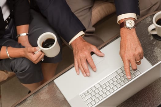 Man and Woman Using Laptop with Coffee