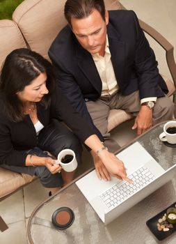 Man and Woman Using Laptop with Coffee