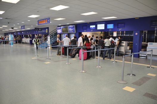 CARDIFF - AUGUST 21 2010: passengers at Cardiff airport at check-in desks on August 21, 2010 in Cardiff, UK