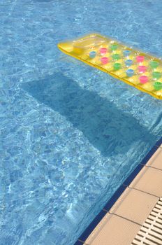 gorgeous swimming pool side with colorful water mattress