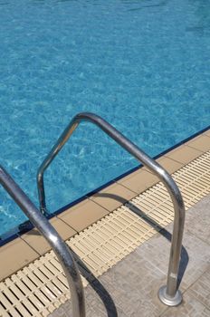 vibrant swimming pool side with ladder