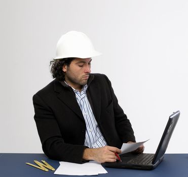 Young architect at work with laptop