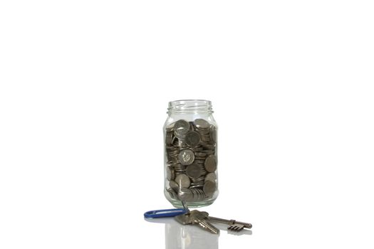 House deposit keys and money in a jar isolated