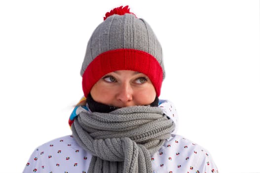 Attractive woman wrapped in a gray scarf is looking up. On a white background. Winter.