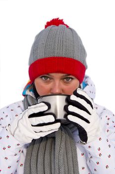 Attractive woman drinking hot tea from a mug. On a white background. Close-up.