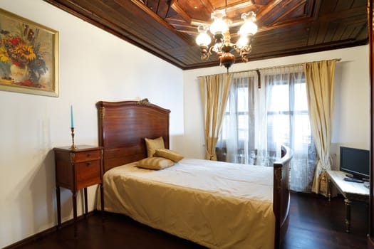Hotel room interior with old style wooden furniture