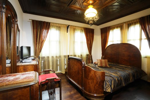 Interior, hotel bedroom with medieval wooden furniture