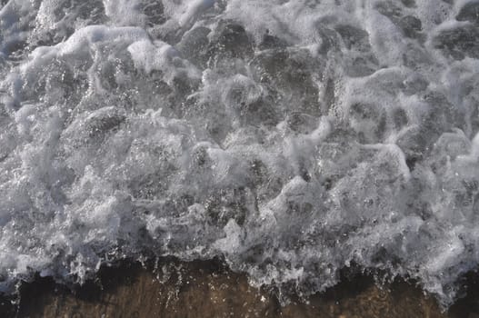 bright ocean water wave as a background or texture