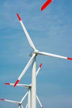 Close-up of heads of nature preserving wind electricity generators 