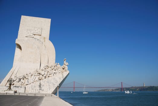 famous monument to the maritime discoveries in Lisbon, Portugal (April 25th bridge on the background)